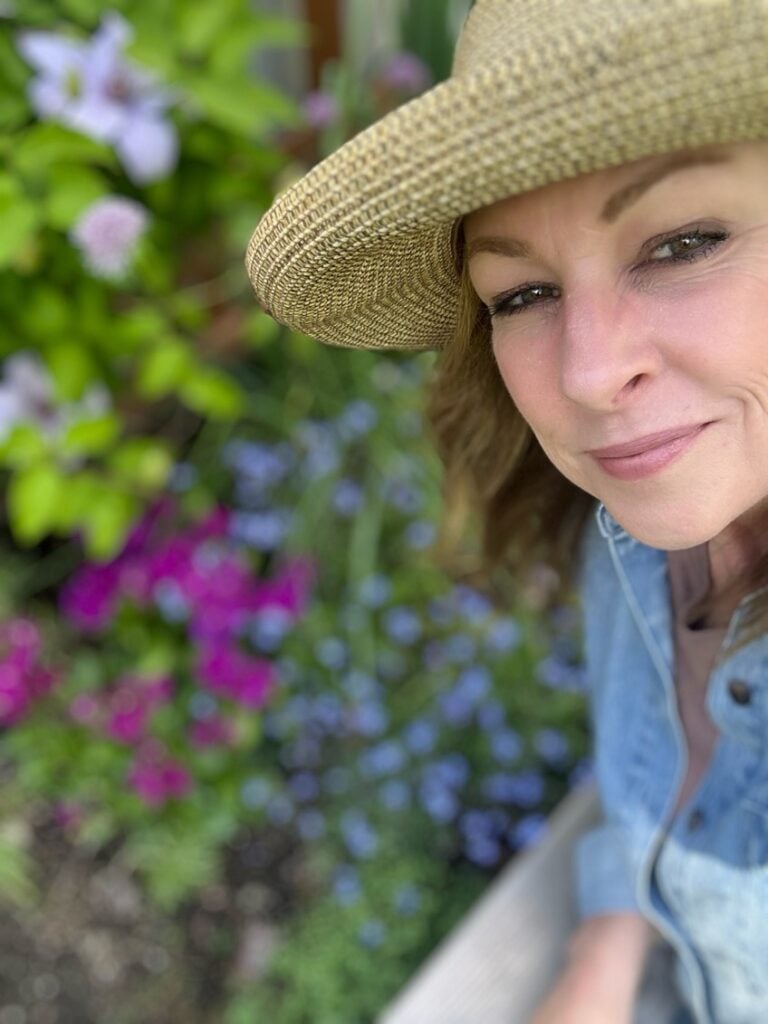 Me in front of some of my flowering plants.