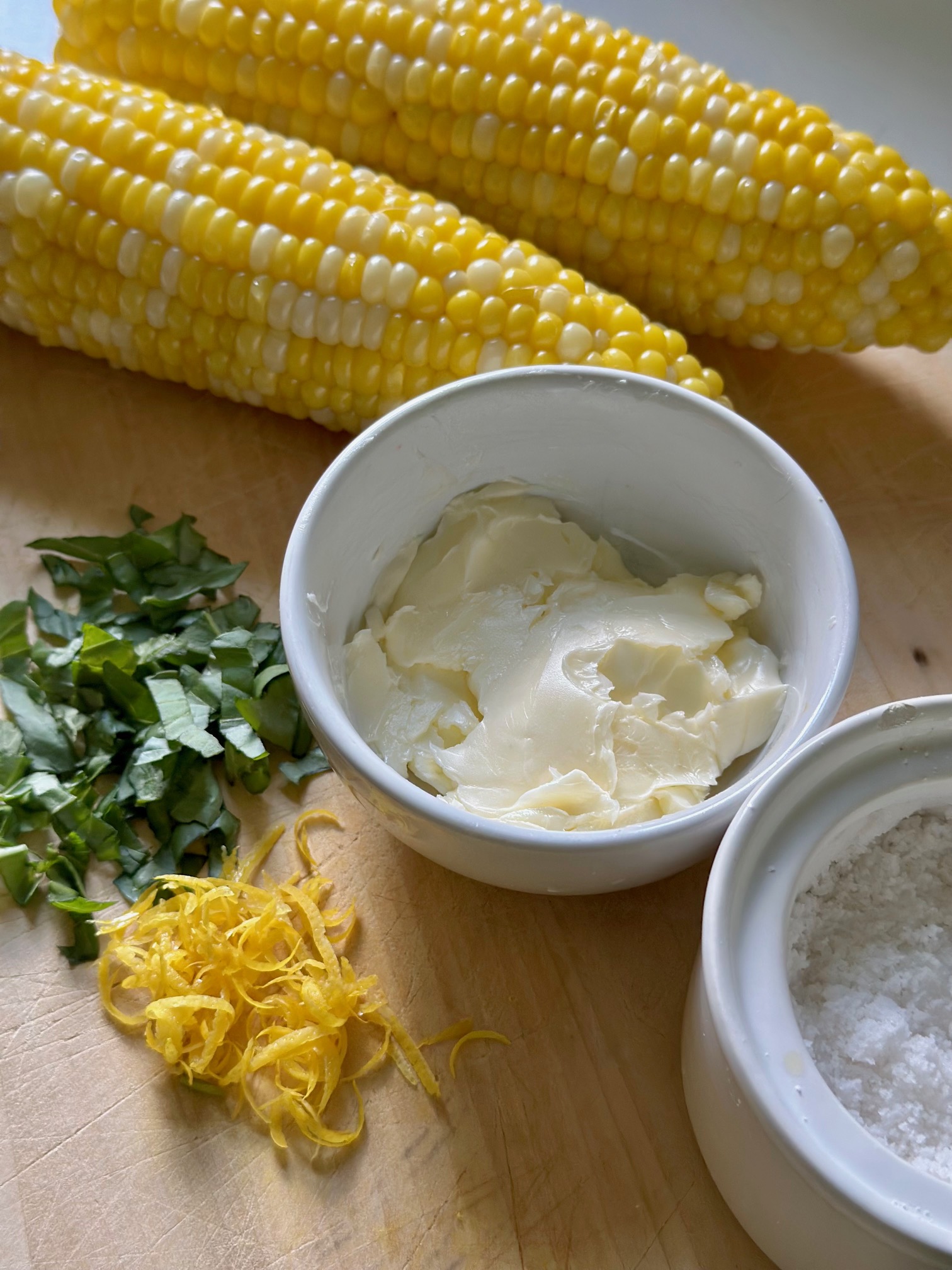 Butter, basil, lemon zest and corn on the cob.