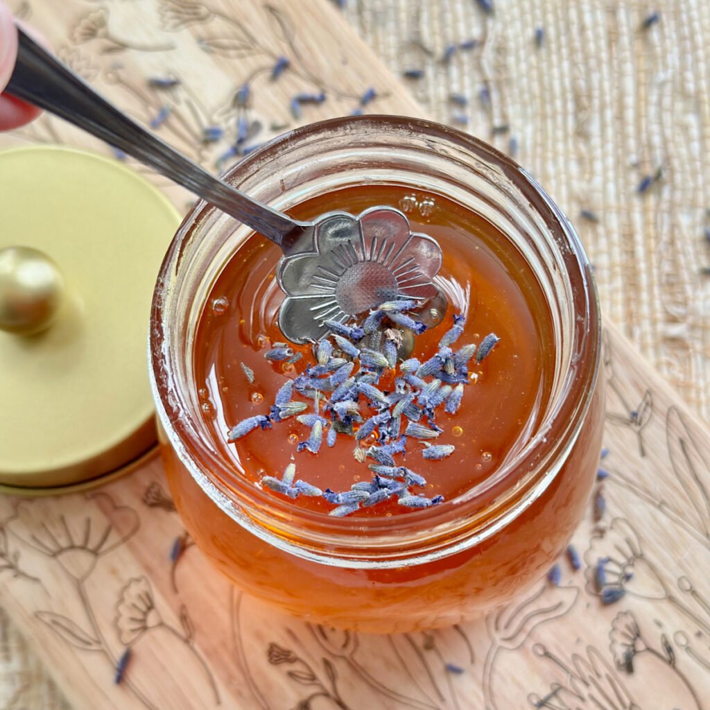 Lavender sprinkled on top of a jar of honey.