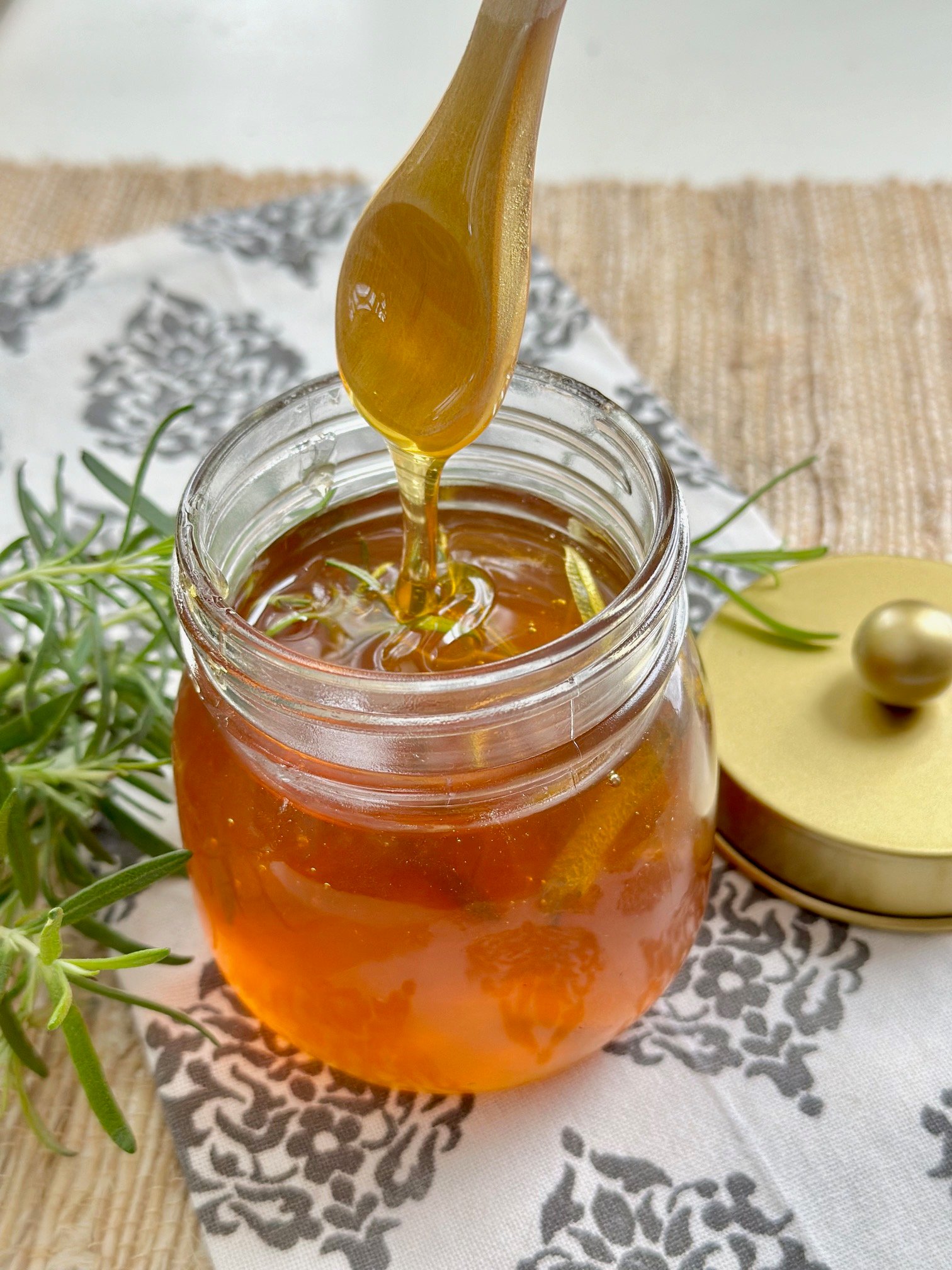 Wooden spoon with rosemary infused honey.